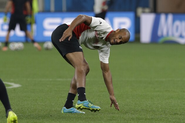 Belgium national soccer team player Vincent Kompany slips during an official training session the day before the group H World Cup soccer match between South Korea and Belgium at the Itaquerao Stadium in Sao Paulo, Brazil, Wednesday, June 25, 2014. (AP Photo/Lee Jin-man)