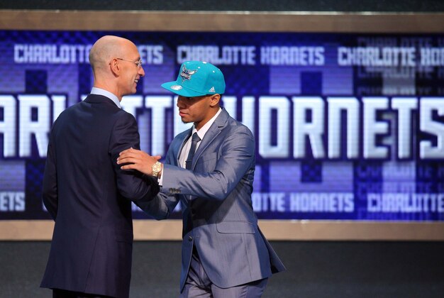 Jun 26, 2014; Brooklyn, NY, USA; Shabazz Napier (Connecticut) shakes hands with NBA commissioner Adam Silver after being selected as the number twenty-four overall pick to the Charlotte Hornets in the 2014 NBA Draft at the Barclays Center. Mandatory Credit: Brad Penner-USA TODAY Sports