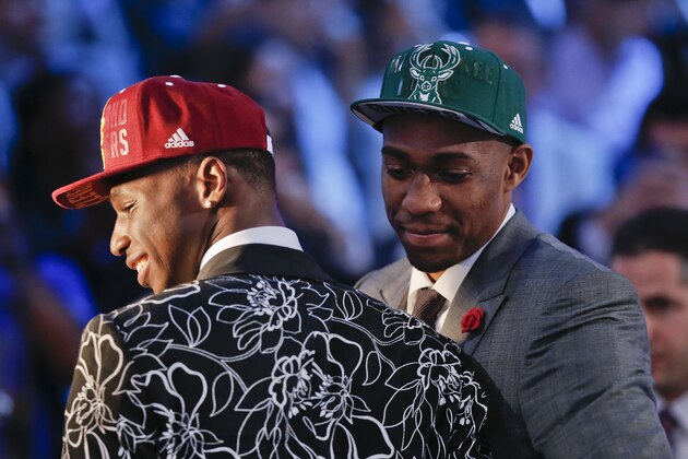 Andrew Wiggins, left, and Jabari Parker stop for television interviews after being selected as the top two picks in the 2014 NBA draft, Thursday, June 26, 2014, in New York. Wiggins was selected number one by the Cleveland Cavaliers and Parker was chosen number two by the Milwaukee Bucks. (AP Photo/Kathy Willens)