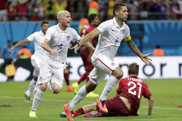 United States' Clint Dempsey (8) celebrates with teammate Michael Bradley after scoring his side's second goal during the group G World Cup soccer match between the United States and Portugal at the Arena da Amazonia in Manaus, Brazil, Sunday, June 22, 2014. (AP Photo/Julio Cortez)
