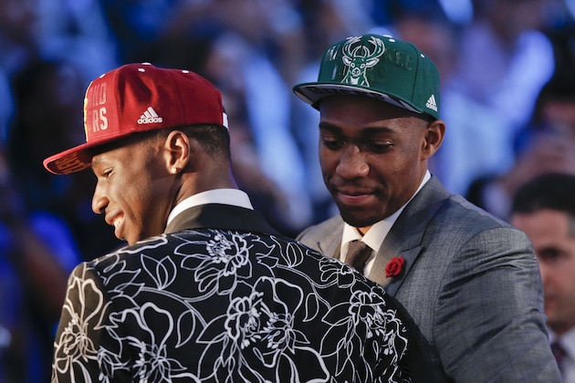 Andrew Wiggins, left, and Jabari Parker stop for television interviews after being selected as the top two picks in the 2014 NBA draft, Thursday, June 26, 2014, in New York. Wiggins was selected number one by the Cleveland Cavaliers and Parker was chosen number two by the Milwaukee Bucks. (AP Photo/Kathy Willens)