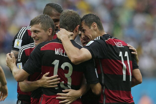 Germany's Miroslav Klose, right, congratulates Thomas Mueller after he scored the opening goal during the group G World Cup soccer match between the USA and Germany at the Arena Pernambuco in Recife, Brazil, Thursday, June 26, 2014. (AP Photo/Petr David Josek)