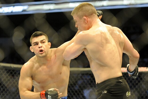 Kelvin Gastelum, left, lands a punch on Rick Story during a UFC 171 mixed martial arts welterweight bout, Saturday, March 15, 2014, in Dallas. Gastelum won by decision. (AP Photo/Matt Strasen)