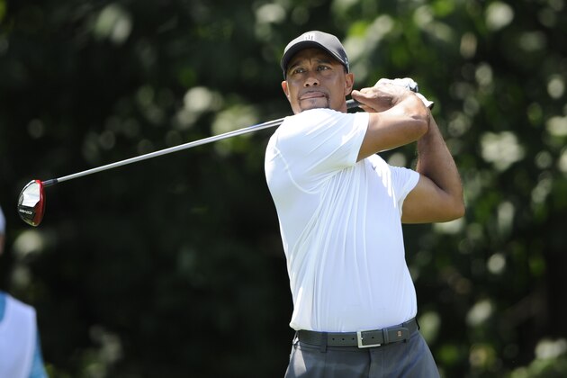 Tiger Woods watches his tee shot on the sixth hole during the second round of the Quicken Loans National golf tournament, Friday, June 27, 2014, in Bethesda, Md. (AP Photo/Nick Wass)