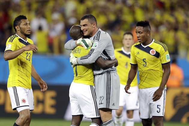 Colombia's goalkeeper Faryd Mondragon, center, is embraced by his teammates after  the group C World Cup soccer match between Japan and Colombia at the Arena Pantanal in Cuiaba, Brazil, Tuesday, June 24, 2014. Colombia won the match 4-1. (AP Photo/Kirsty Wigglesworth)