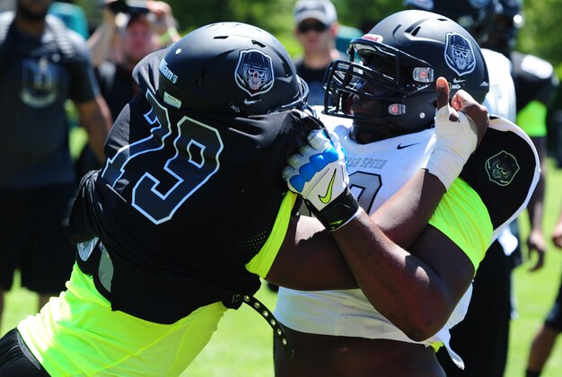 Jul 3, 2013; Beaverton, OR, USA; Defensive lineman Andrew Williams (79) battles offensive lineman Roderick Taylor (72) during the Lineman Challenge session of the 'The Opening' at Nike World Headquarters. Mandatory Credit: Steve Dykes-USA TODAY Sports