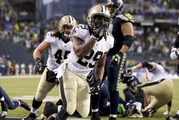New Orleans Saints running back Khiry Robinson (29) celebrates after running for a 1-yard touchdown during the fourth quarter of an NFC divisional playoff NFL football game against the Seattle Seahawks in Seattle, Saturday, Jan. 11, 2014. (AP Photo/Elaine Thompson)