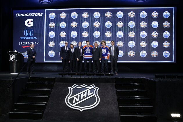 Leon Draisaitl stands with Edmonton Oilers officials after being chosen third overall during the first round of the NHL hockey draft, Friday, June 27, 2014, in Philadelphia. (AP Photo/Matt Slocum)