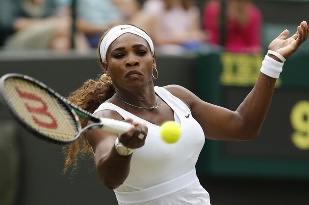 Serena Williams of U.S. plays a return to Chanelle Scheepers of South Africa during their women's singles match at the All England Lawn Tennis Championships in Wimbledon, London, Thursday, June 26, 2014. (AP Photo/Ben Curtis)