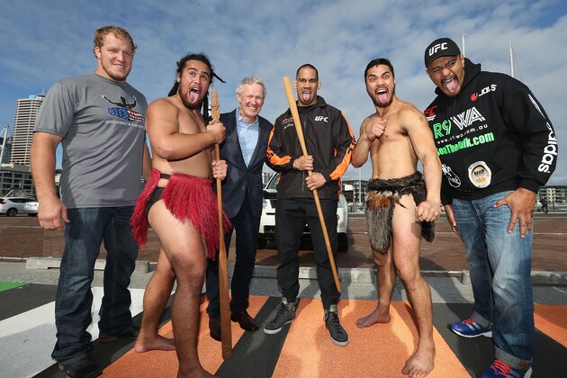 AUCKLAND, NEW ZEALAND - JUNE 24:  UFC Fighters Jared Rosholt of USA (L) James Te Huna (C) and Soa Palelei of Australia (R) join Maori cultural performers Edz Eramiha (R) and Iwi Matthews (L) with UFC Managing Director Tom Wright (in suit) after a traditional maori welcome for UFC fighters at Te Wero Bridge on June 24, 2014 in Auckland, New Zealand.  Fighters were welcomed to Auckland ahead of the UFC fight night on June 28 at Vector Arena.  (Photo by Fiona Goodall/Getty Images)