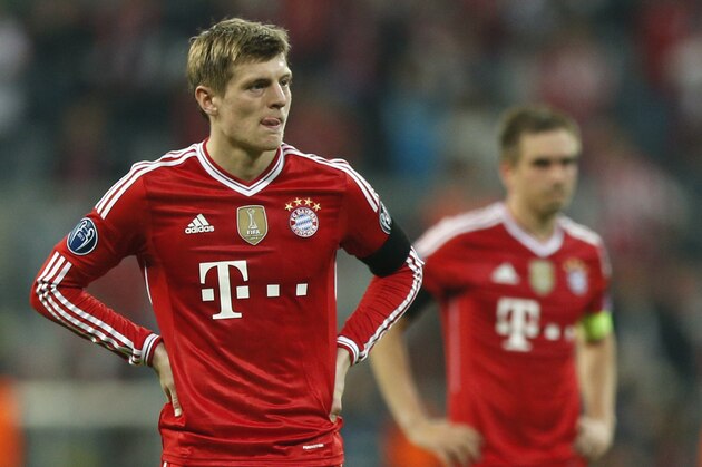 Bayern's Toni Kroos, left, and Philipp Lahm look disappointed after losing the Champions League semifinal second leg soccer match between Bayern Munich and Real Madrid at the Allianz Arena in Munich, southern Germany, Tuesday, April 29, 2014. (AP Photo/Matthias Schrader)