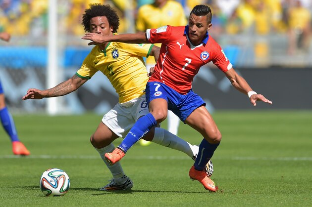 BELO HORIZONTE, BRAZIL - JUNE 28:  Alexis Sanchez of Chile and Marcelo of Brazil compete for the ball during the 2014 FIFA World Cup Brazil round of 16 match between Brazil and Chile at Estadio Mineirao on June 28, 2014 in Belo Horizonte, Brazil.  (Photo by Buda Mendes/Getty Images)