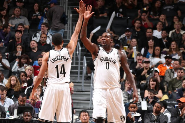 NEW YORK, NY - OCTOBER 12: Teammates Shaun Livingston #14 and Andray Blatche #0 of the Brooklyn Nets high-five during a preseason game against the Detroit Pistons at the Barclays Center on October 12, 2013 in the Brooklyn borough of New York City.  NOTE TO USER: User expressly acknowledges and agrees that, by downloading and/or using this Photograph, user is consenting to the terms and conditions of the Getty Images License Agreement. Mandatory Copyright Notice: Copyright 2013 NBAE (Photo by Nathaniel S. Butler/NBAE via Getty Images)