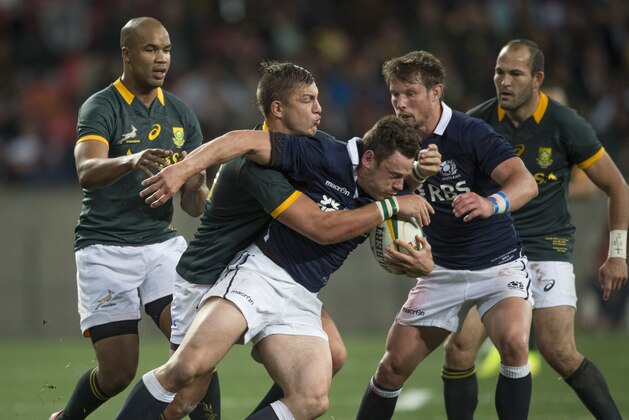 South Africa's Handre Pollard centre left, tackles Nick De Luca of Scotland, during their Rugby test match in Port Elizabeth, South Africa, Saturday, June 28, 2014. (AP Photo)