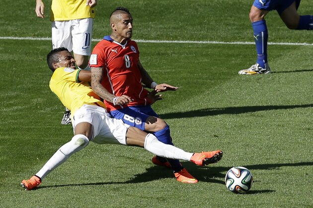 Chile's Arturo Vidal is fouled by Brazil's Luiz Gustavo, left, during the World Cup round of 16 soccer match between Brazil and Chile at the Mineirao Stadium in Belo Horizonte, Brazil, Saturday, June 28, 2014. (AP Photo/Hassan Ammar)