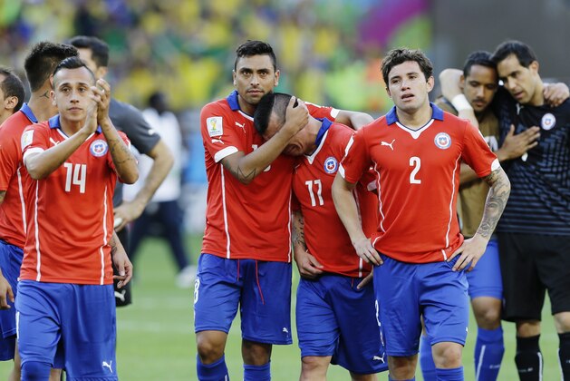 Chilean players walk off the pitch after a penalty shootout following regulation time during the World Cup round of 16 soccer match between Brazil and Chile at the Mineirao Stadium in Belo Horizonte, Brazil, Saturday, June 28, 2014. Brazil won 3-2 on penalties after a 1-1 tie. (AP Photo/Ricardo Mazalan)