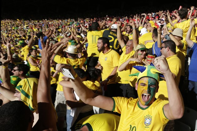 Brazil soccer fans celebrate their team's victory over Chile after a penalty shootout at a World Cup round of 16 match at Mineirao Stadium in Belo Horizonte, Brazil, Saturday, June 28, 2014. (AP Photo/Petr David Josek)