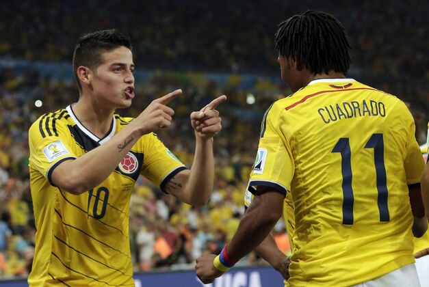 Colombia's James Rodriguez (10) celebrates with his teammate Juan Cuadrado (11) after he scored his side's second goal during the World Cup round of 16 soccer match between Colombia and Uruguay at the Maracana Stadium in Rio de Janeiro, Brazil, Saturday, June 28, 2014. (AP Photo/Marcio Jose Sanchez)