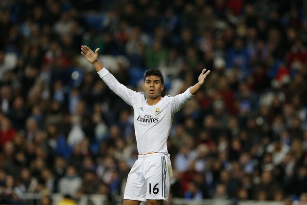 Real's Casemiro protests during a Copa del Rey soccer match between Real Madrid and third-division club Xativa Olimpic at the Bernabeu stadium in Madrid, Wednesday Dec. 2013. (AP Photo/Paul White)