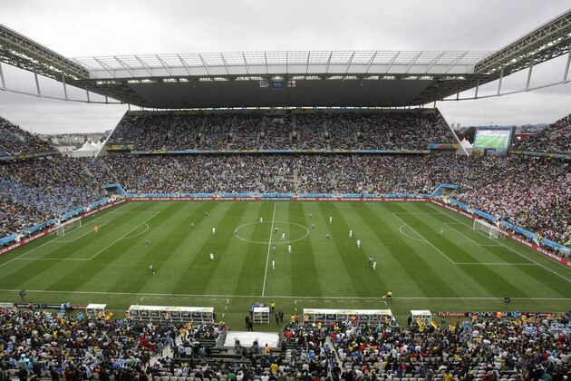 People watch the group D World Cup soccer match between Uruguay and England at the Itaquerao Stadium in Sao Paulo, Brazil, Thursday, June 19, 2014.  (AP Photo/Michael Sohn)