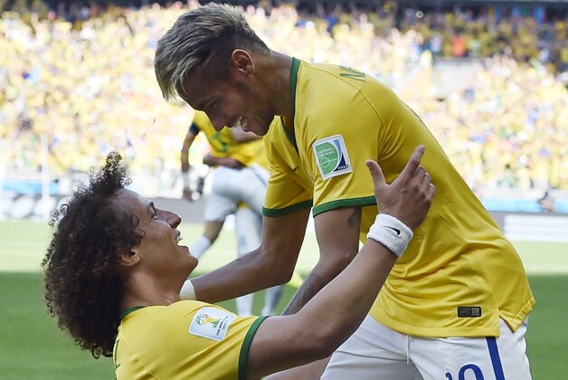Brazil's David Luiz, left, and Neymar celebrate after Brazil's opening goal during the World Cup round of 16 soccer match between Brazil and Chile at the Mineirao Stadium in Belo Horizonte, Brazil, Saturday, June 28, 2014. (AP Photo/Martin Meissner)