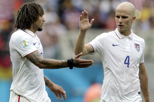 United States' Michael Bradley, right, congratulates his teammate Jermaine Jones after qualifying for the next World Cup round following their 1-0 loss to Germany during the group G World Cup soccer match between the USA and Germany at the Arena Pernambuco in Recife, Brazil, Thursday, June 26, 2014. (AP Photo/Julio Cortez)