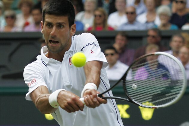 Novak Djokovic of Serbia plays a return against Gilles Simon of France during the men's singles match at the All England Lawn Tennis Championships in Wimbledon, London, Friday, June 27, 2014. (AP Photo/Sang Tan)