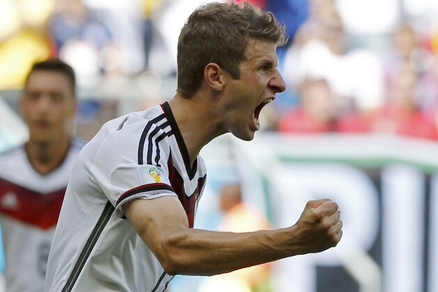 Germany's Thomas Mueller celebrates after scoring the opening goal during the group G World Cup soccer match between Germany and Portugal at the Arena Fonte Nova in Salvador, Brazil, Monday, June 16, 2014.  (AP Photo/Matthias Schrader)
