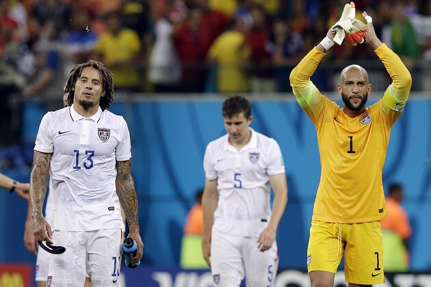 United States' goalkeeper Tim Howard and United States' Jermaine Jones walk off the pitch following their 2-2 draw with Portugal during the group G World Cup soccer match between the USA and Portugal at the Arena da Amazonia in Manaus, Brazil, Sunday, June 22, 2014. (AP Photo/Martin Mejia)