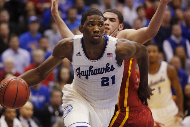 FILE - In this Jan. 29, 2014 file photo, Kansas center Joel Embiid (21) works around Iowa State forward Georges Niang, back, during the first half of an NCAA college basketball game in Lawrence, Kan. Embiid is a possible pick in the 2014 NBA Draft, Thursday, June 26, 2014 in New York.(AP Photo/Orlin Wagner, File)