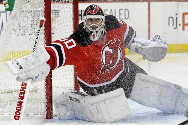 FILE - In this March 4, 2014, file photo, New Jersey Devils goaltender Martin Brodeur deflects the puck during the first period of an NHL hockey game against the Detroit Red Wings in Newark, N.J. Brodeur has re-emerged as the Devils No. 1 goaltender after winning four straight games. (AP Photo/Bill Kostroun, File)