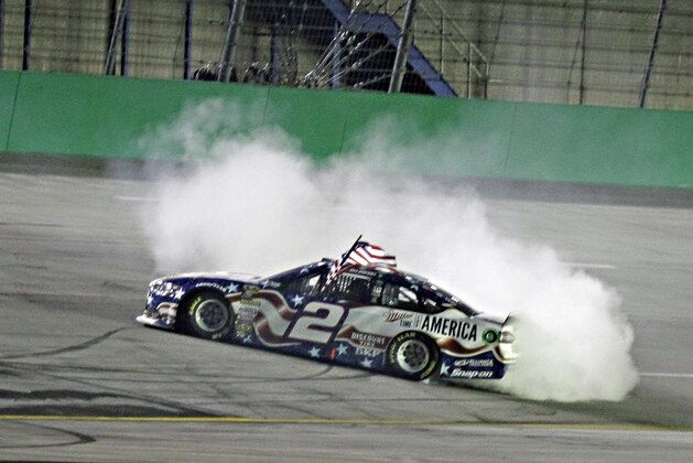 Brad Keselowski does a burnout after winning the NASCAR Sprint Cup series auto race Saturday, June 28, 2014, at Kentucky Speedway in Sparta, Ky. (AP Photo/Garry Jones)