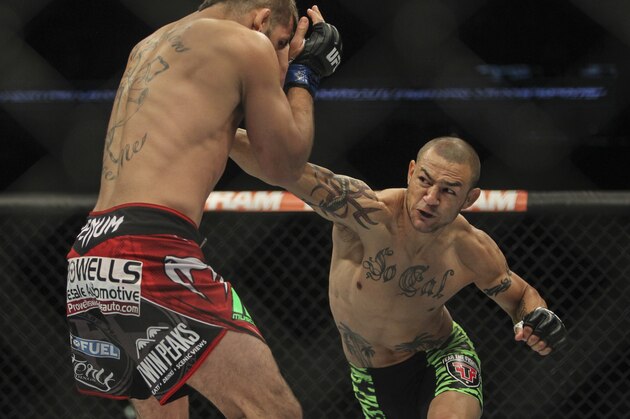 Jun 28, 2014; San Antonio, TX, USA; Cub Swanson (red gloves) fights Jeremy Stephens (blue gloves) in a Featherweight bout at UFC Fight Night 43 at AT&T Center. Mandatory Credit: Troy Taormina-USA TODAY Sports