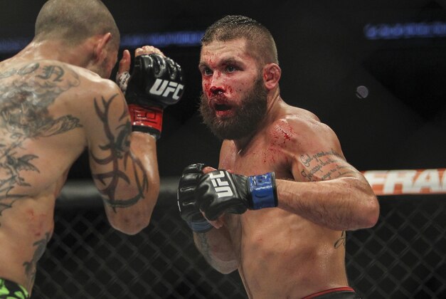 Jun 28, 2014; San Antonio, TX, USA; Cub Swanson (red gloves) fights Jeremy Stephens (blue gloves) in a Featherweight bout at UFC Fight Night 43 at AT&T Center. Mandatory Credit: Troy Taormina-USA TODAY Sports