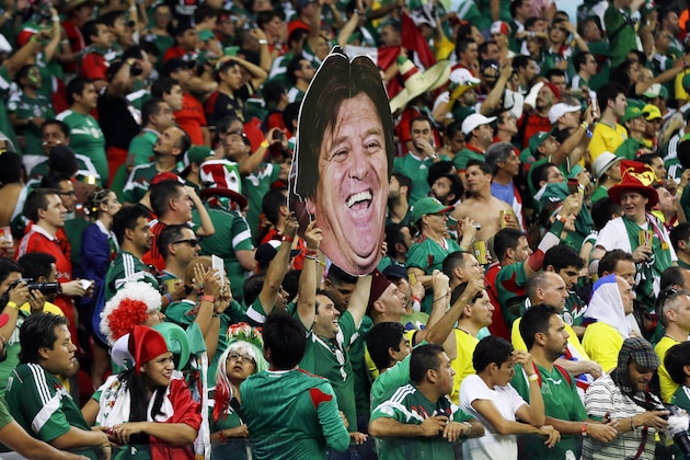 Mexico's fans celebrate holding a mask of Mexico's head coach Miguel Herrera after  the group A World Cup soccer match between Croatia and Mexico at the Arena Pernambuco in Recife, Brazil, Monday, June 23, 2014. Mexico won 3-1. (AP Photo/Ricardo Mazalan)