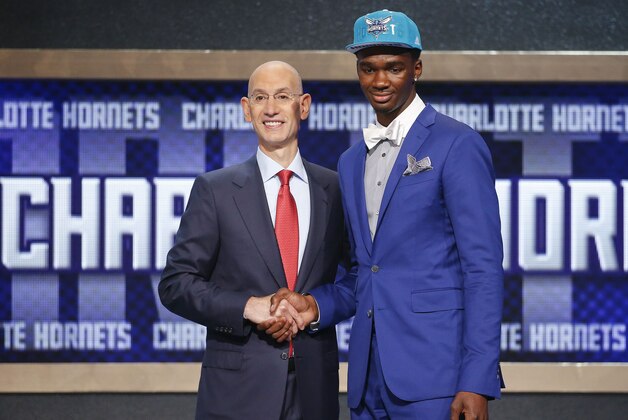 Indiana's Noah Vonleh, right, poses for a photo with NBA Commissioner Adam Silver after being selected ninth overall by the Charlotte Hornets during the 2014 NBA draft, Thursday, June 26, 2014, in New York. (AP Photo/Jason DeCrow)