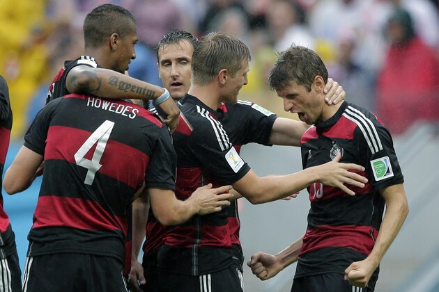Germany's Thomas Mueller, right, celebrates scoring the opening goal during the group G World Cup soccer match between the USA and Germany at the Arena Pernambuco in Recife, Brazil, Thursday, June 26, 2014. (AP Photo/Matthias Schrader)