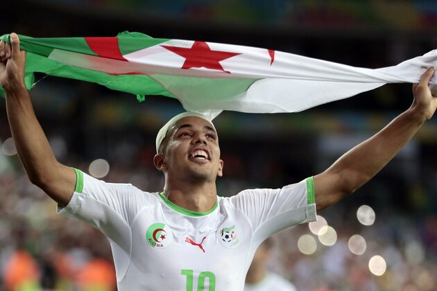 Algeria's Sofiane Feghouli celebrates after the group H World Cup soccer match between Algeria and Russia at the Arena da Baixada in Curitiba, Brazil, Thursday, June 26, 2014. The match ended in a 1-1 draw, but Algeria qualified for the round of 16. (AP Photo/Ivan Sekretarev)