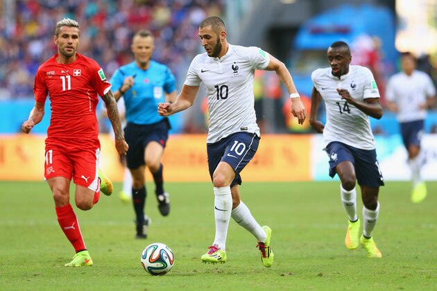 SALVADOR, BRAZIL - JUNE 20:  Karim Benzema of France controls the ball as Valon Behrami of Switzerland gives chase during the 2014 FIFA World Cup Brazil Group E match between Switzerland and France at Arena Fonte Nova on June 20, 2014 in Salvador, Brazil.  (Photo by Elsa/Getty Images)