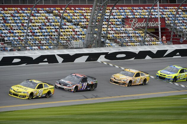 Matt Kenseth (20), Denny Hamlin (11), Kyle Busch (18) and Paul Menard (27) run laps during a practice session for the Daytona 500 NASCAR Sprint Cup Series auto race at Daytona International Speedway in Daytona Beach, Fla., Friday, Feb. 21, 2014. (AP Photo/Phelan M. Ebenhack)