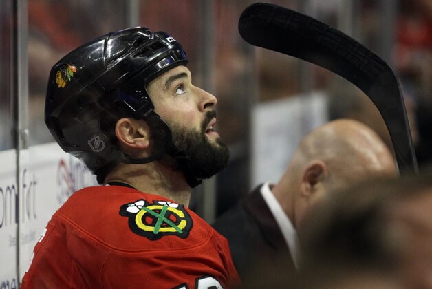 Chicago Blackhawks' Brandon Bollig (52) looks up the score board from the penalty box during the third period in Game 2 of the Western Conference finals in the NHL hockey Stanley Cup playoffs against the Los Angeles Kings in Chicago on Wednesday, May 21, 2014. The Kings won 6-2. (AP Photo/Nam Y. Huh)