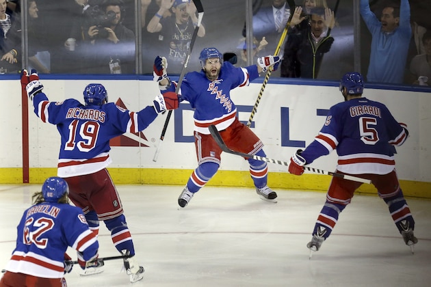 New York Rangers' Martin St. Louis, center, celebrates his game-winning goal during overtime in Game 4 of the NHL hockey Stanley Cup playoffs Eastern Conference finals against the Montreal Canadiens, Sunday, May 25, 2014, in New York. The Rangers defeated the Canadiens in overtime 3-2. (AP Photo/Seth Wenig) New York Rangers' Martin St. Louis, center, celebrates his game-winning goal during overtime in Game 4 of the NHL hockey Stanley Cup playoffs Eastern Conference finals against the Montreal Canadiens, Sunday, May 25, 2014, in New York. The Rangers defeated the Canadiens in overtime 3-2. (AP Photo/Seth Wenig)