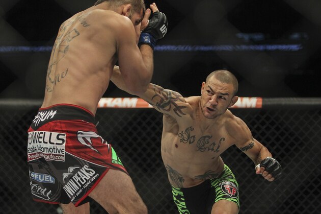 Jun 28, 2014; San Antonio, TX, USA; Cub Swanson (red gloves) fights Jeremy Stephens (blue gloves) in a Featherweight bout at UFC Fight Night 43 at AT&T Center. Mandatory Credit: Troy Taormina-USA TODAY Sports