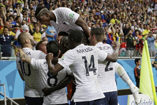 French players celebrate after France's Karim Benzema, left,  scored his side's fourth goal during the group E World Cup soccer match between Switzerland and France at the Arena Fonte Nova in Salvador, Brazil, Friday, June 20, 2014.    (AP Photo/Christophe Ena)