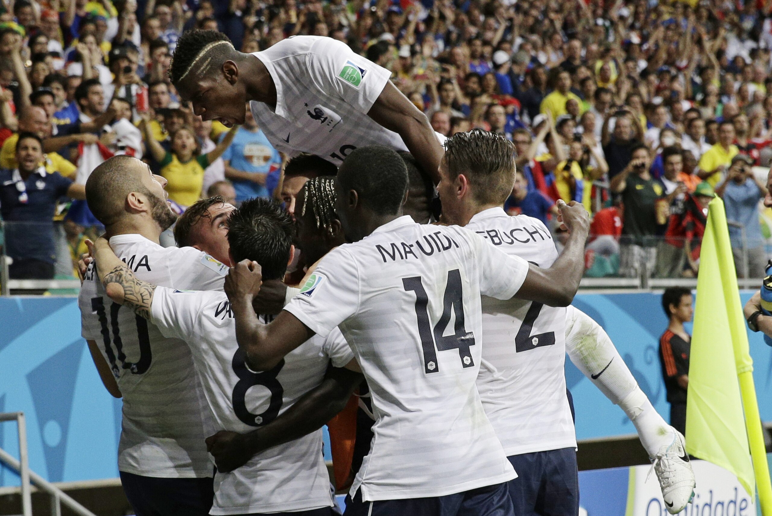 French players celebrate after France's Karim Benzema, left,  scored his side's fourth goal during the group E World Cup soccer match between Switzerland and France at the Arena Fonte Nova in Salvador, Brazil, Friday, June 20, 2014.    (AP Photo/Christophe Ena)