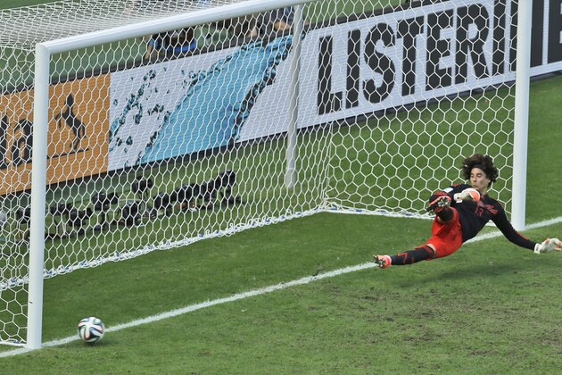 Mexico's goalkeeper Guillermo Ochoa fails to save a shot by Netherlands' Klaas-Jan Huntelaar from the penalty spot during the World Cup round of 16 soccer match between the Netherlands and Mexico at the Arena Castelao in Fortaleza, Brazil, Sunday, June 29, 2014. Holland won 2-1 and advanced to the quarterfinal.  (AP Photo/Themba Hadebe)