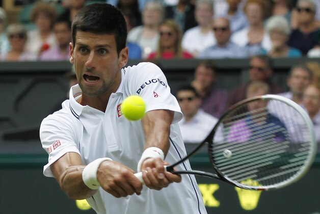 Novak Djokovic of Serbia plays a return against Gilles Simon of France during the men's singles match at the All England Lawn Tennis Championships in Wimbledon, London, Friday, June 27, 2014. (AP Photo/Sang Tan)