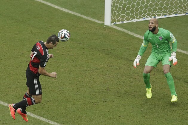 Germany's Miroslav Klose heads the ball towards the goal which goes wide past United States' goalkeeper Tim Howard during the group G World Cup soccer match between the USA and Germany at the Arena Pernambuco in Recife, Brazil, Thursday, June 26, 2014. (AP Photo/Hassan Ammar)