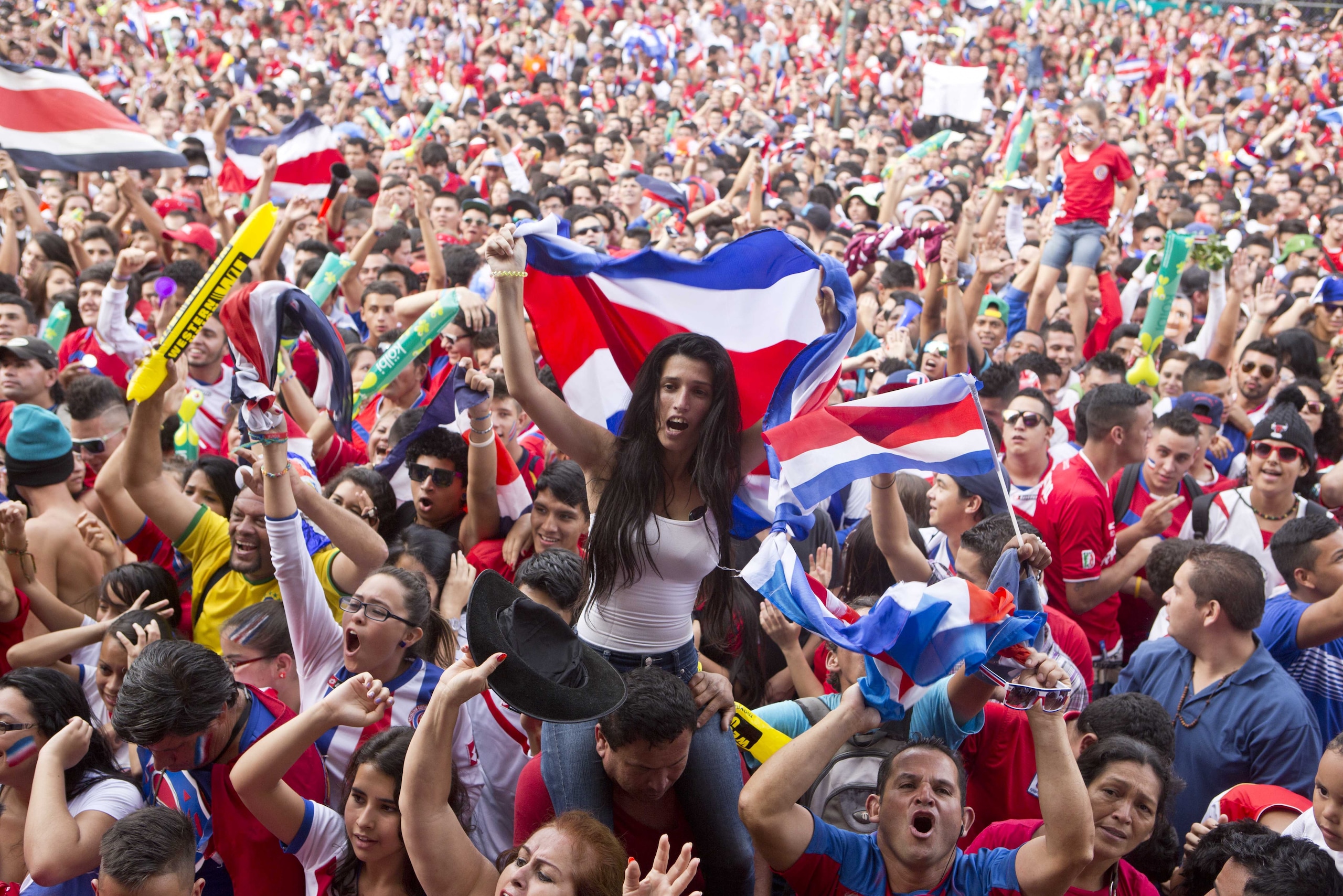 Costa Rica soccer fans celebrate a goal against Greece as they watch the World Cup round of 16 match on TV set up in a public square in San Jose, Costa Rica, Sunday, June 29, 2014. (AP Photo/Esteban Felix) Costa Rica soccer fans celebrate a goal against Greece as they watch the World Cup round of 16 match on TV set up in a public square in San Jose, Costa Rica, Sunday, June 29, 2014. (AP Photo/Esteban Felix)