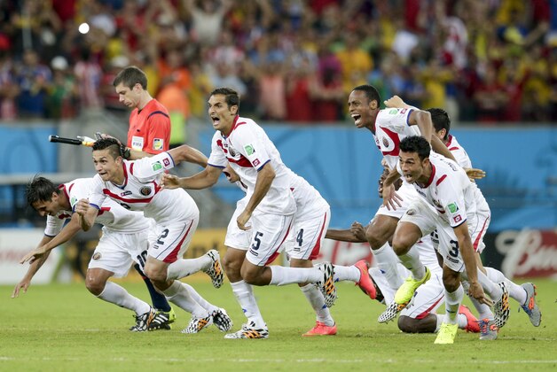 Costa Rica players react after Michael Umana scored during a shootout after regulation time in the World Cup round of 16 soccer match between Costa Rica and Greece at the Arena Pernambuco in Recife, Brazil, Sunday, June 29, 2014. Costa Rica defeated Greece 5-3 in penalty shootouts after a 1-1 tie. (AP Photo/Petr David Josek)